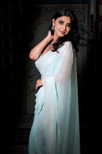 Aarzoo-Glam collection couture saree . Silver sequins and cutdana on a aqua blue georgette base, saree.