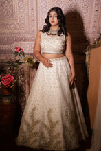 KRISHA - Ivory Net Embroidered  With Stone And Pearls Reception Lehenga.