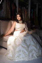 KRISHA - Ivory Net Embroidered  With Stone And Pearls Reception Lehenga.